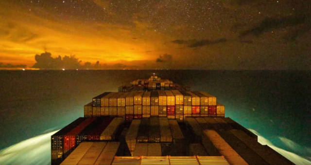 A container ship traveling at night - timelapse