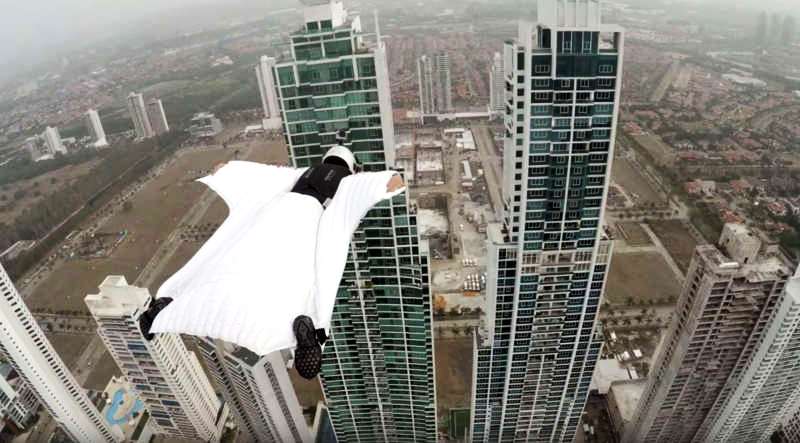 Woman in Wingsuit flies between two buildings