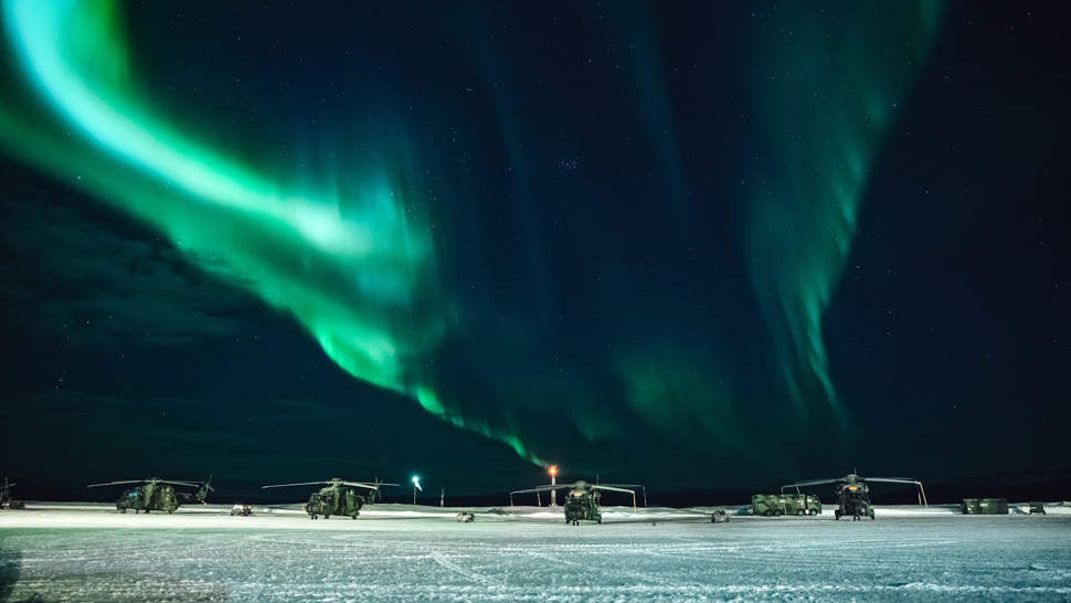 Helicopters under Aurora Borealis