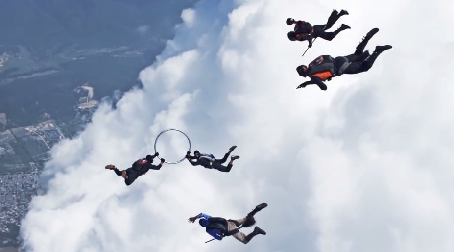 Skydivers Playing a Game of Quidditch in plain air