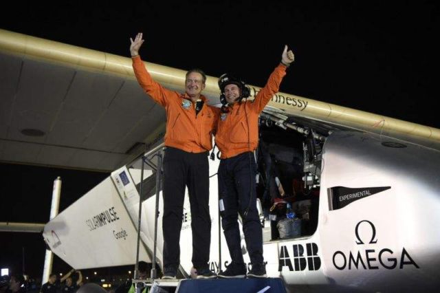 Andre Borschberg (L) and Bertrand Piccard after Solar Impulse 2 touches down in Abu Dhabi