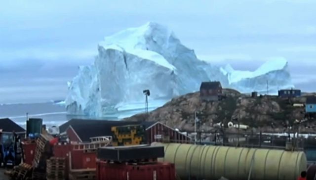 Gigantic Iceberg looms over Greenland village 1