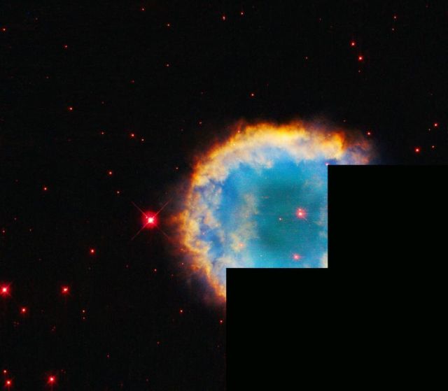 Hubble's Colorful Planetary Nebula Ringed by Hazy Halo