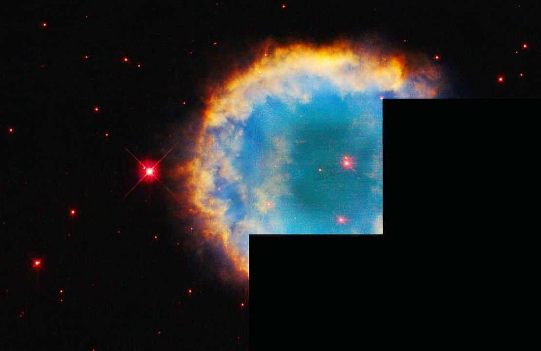 Hubble's Colorful Planetary Nebula Ringed by Hazy Halo
