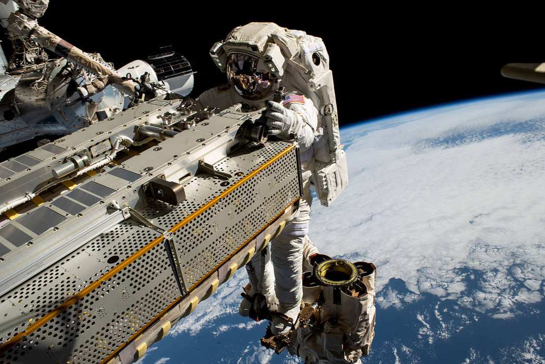 Spacewalker Rides the Canadarm2 Robotic Arm